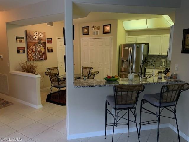 Living area with light tile patterned flooring