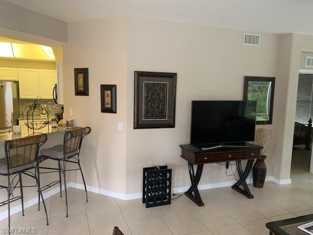 Dining area featuring light tile patterned floors and ceiling fan