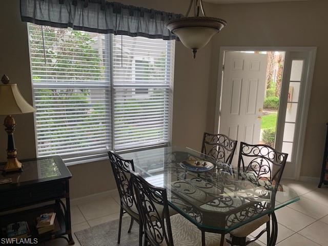 Dining room featuring light tile patterned floors and healthy amount of natural light