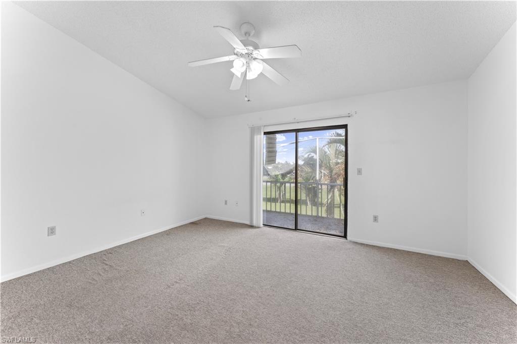 Unfurnished room with ceiling fan and carpet