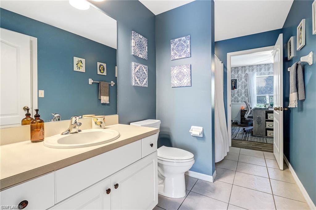 Bathroom featuring vanity, tile patterned flooring, and curtained shower