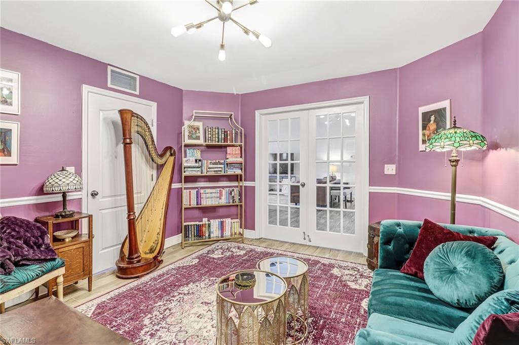 Living area featuring wood finished floors and a chandelier