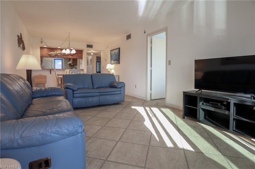Living area featuring a chandelier and tile patterned floors