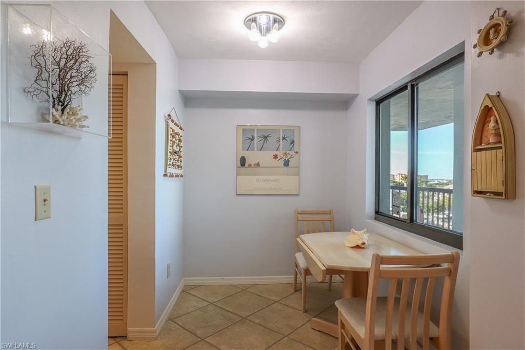 Dining area with light tile patterned floors and baseboards