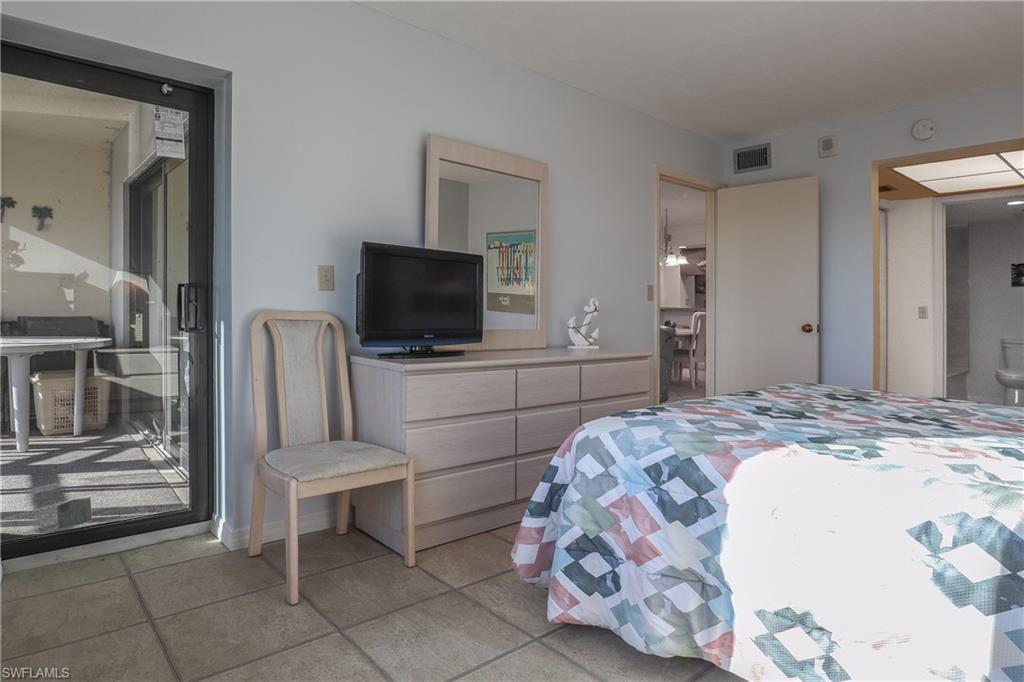Bedroom featuring light tile patterned floors and ensuite bath