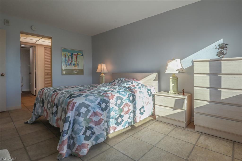Bedroom featuring tile patterned floors and a closet