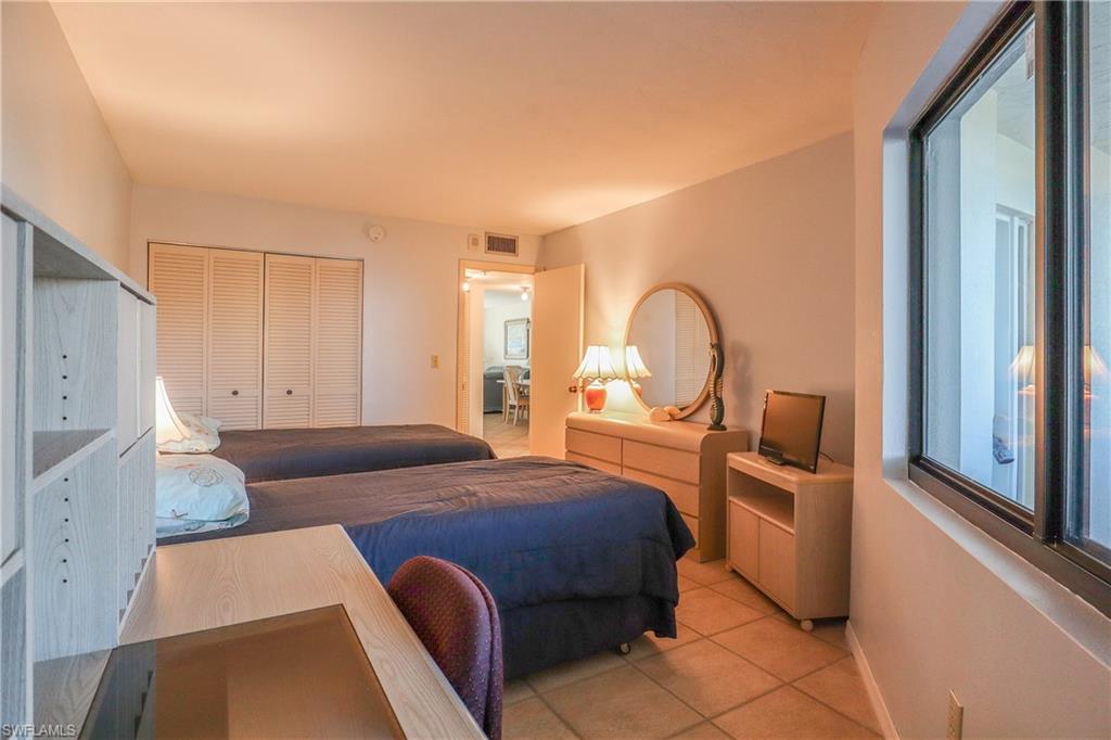 Tiled bedroom with a closet