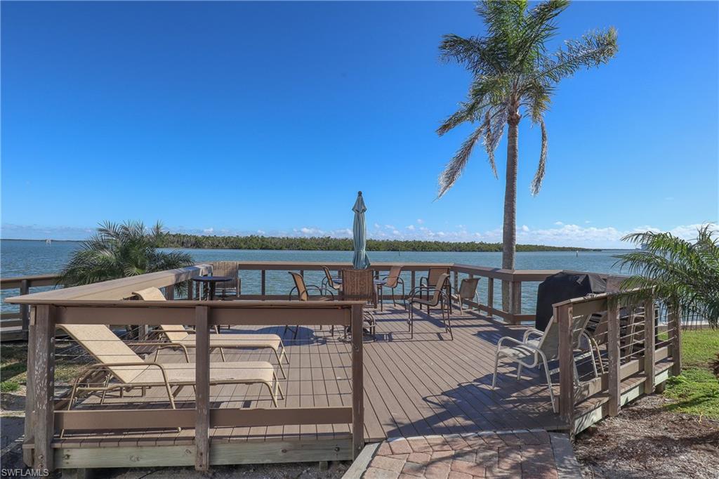 Wooden terrace featuring a water view of Estero Bay