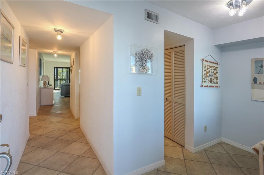 Hallway featuring light tile patterned flooring