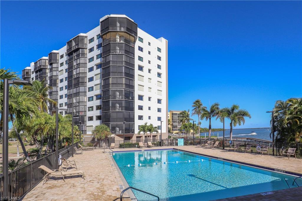 Community pool featuring a patio area and a water view
