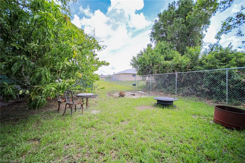 View of yard with an outdoor fire pit