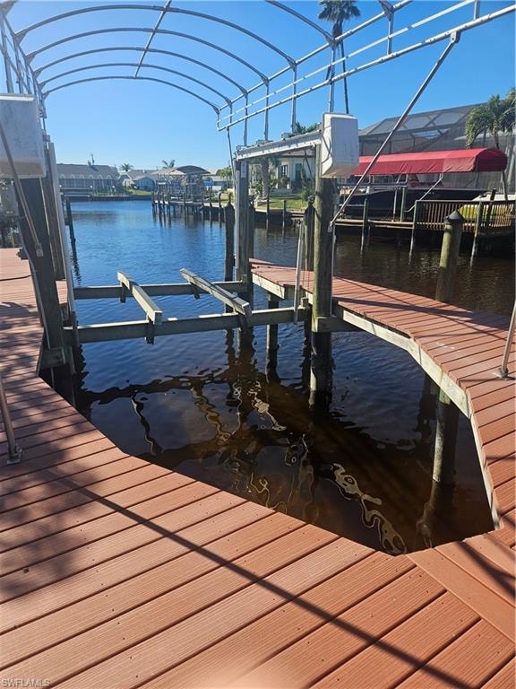 Dock area with boat lift and a water view