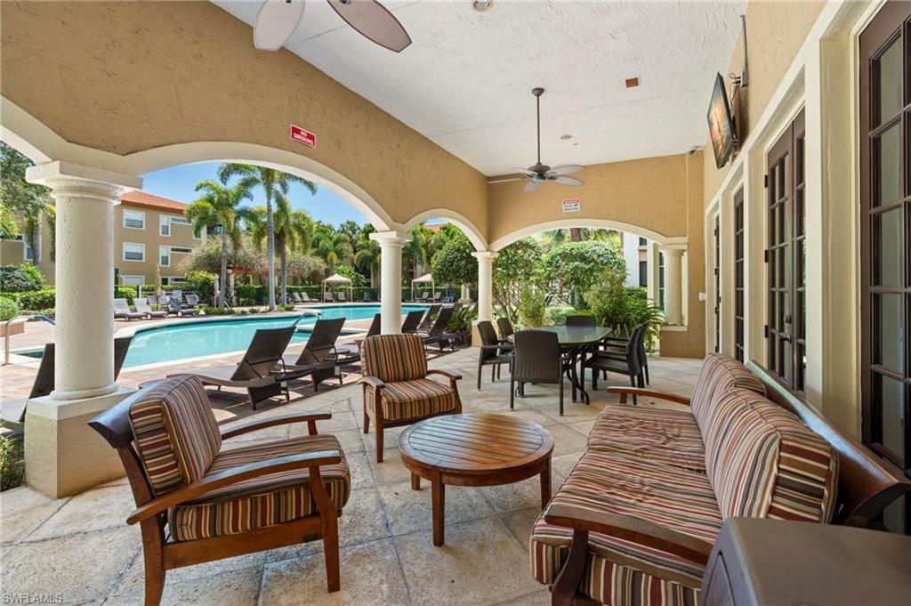 View of patio / terrace featuring a ceiling fan and a community pool