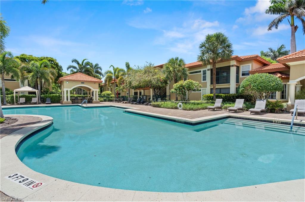 Community pool with a patio