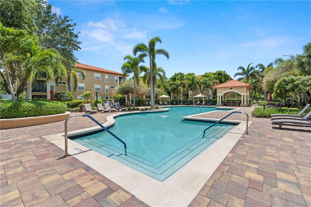 Community pool with a patio area and a gazebo