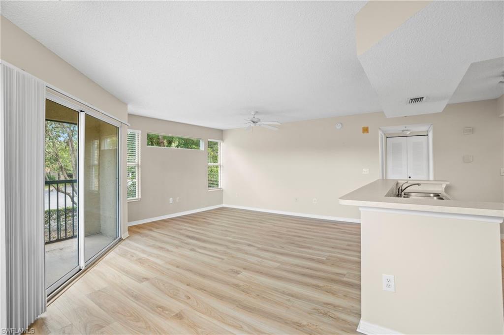 Unfurnished living room featuring light wood finished floors and ceiling fan