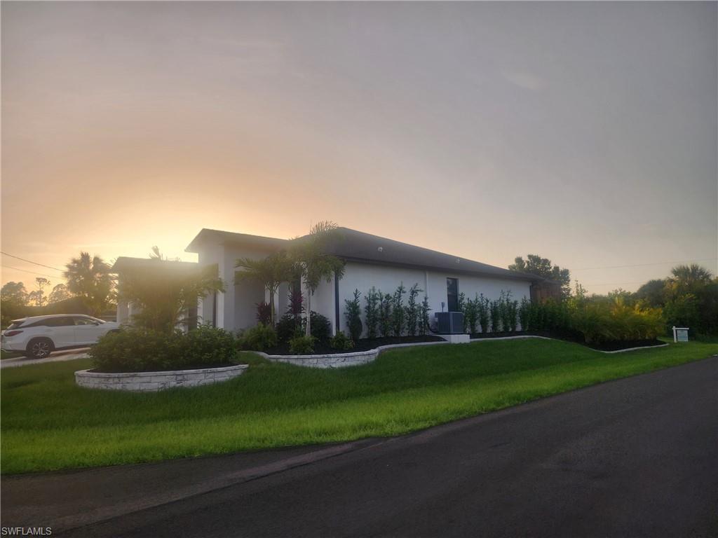 View of front of home with a front yard and stucco siding