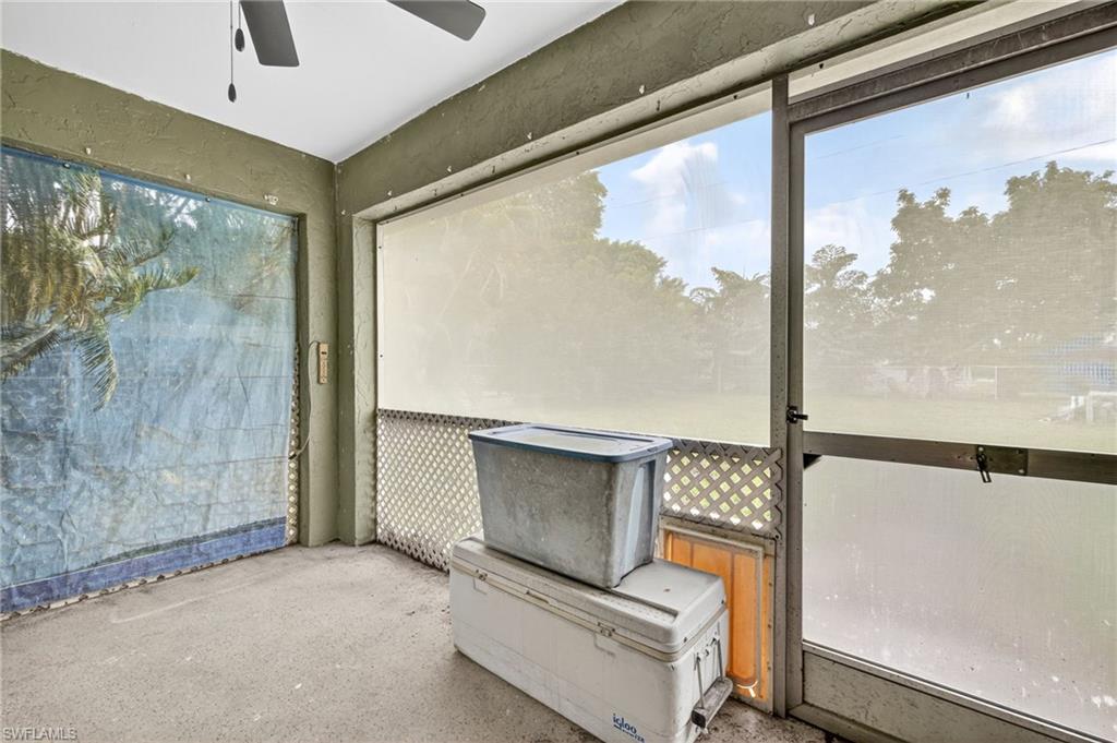 Unfurnished sunroom featuring ceiling fan