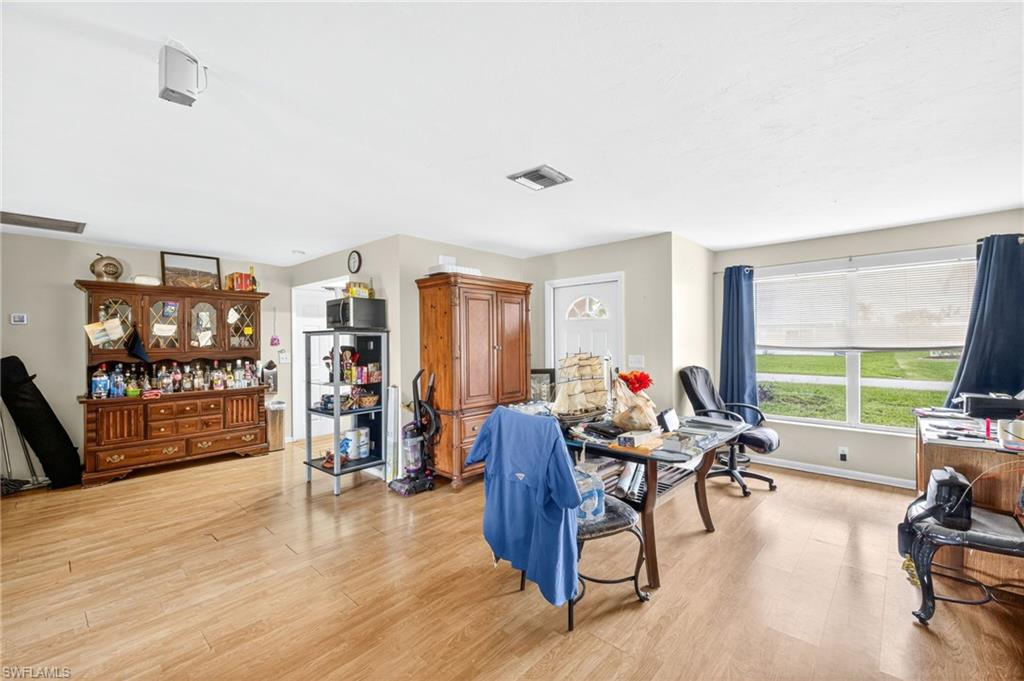 Living room featuring light wood finished floors and an office area