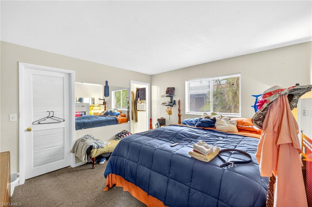 Carpeted bedroom with multiple windows