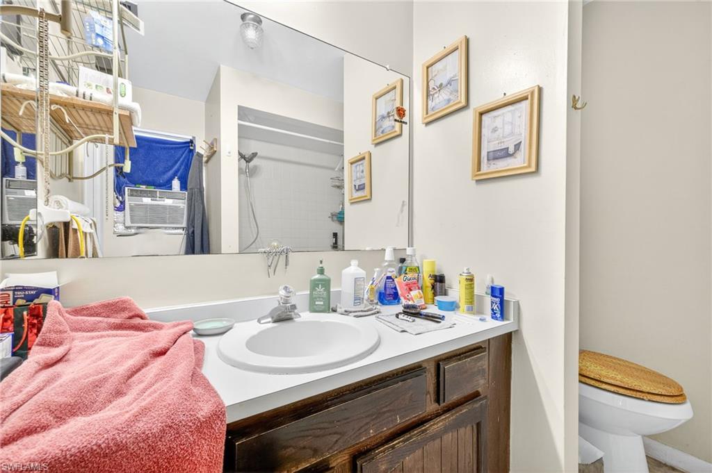 Bathroom featuring a shower and vanity