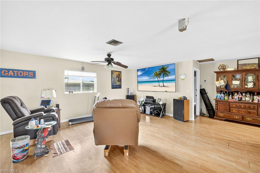 Living room with a ceiling fan and light wood finished floors