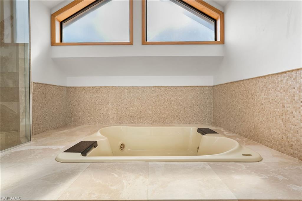 Bathroom featuring a bath and tile patterned flooring