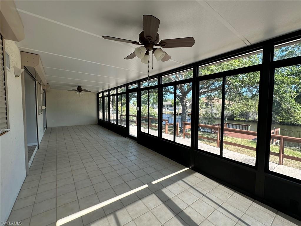 Bright primary bedroom with French Doors leading to bonus room.