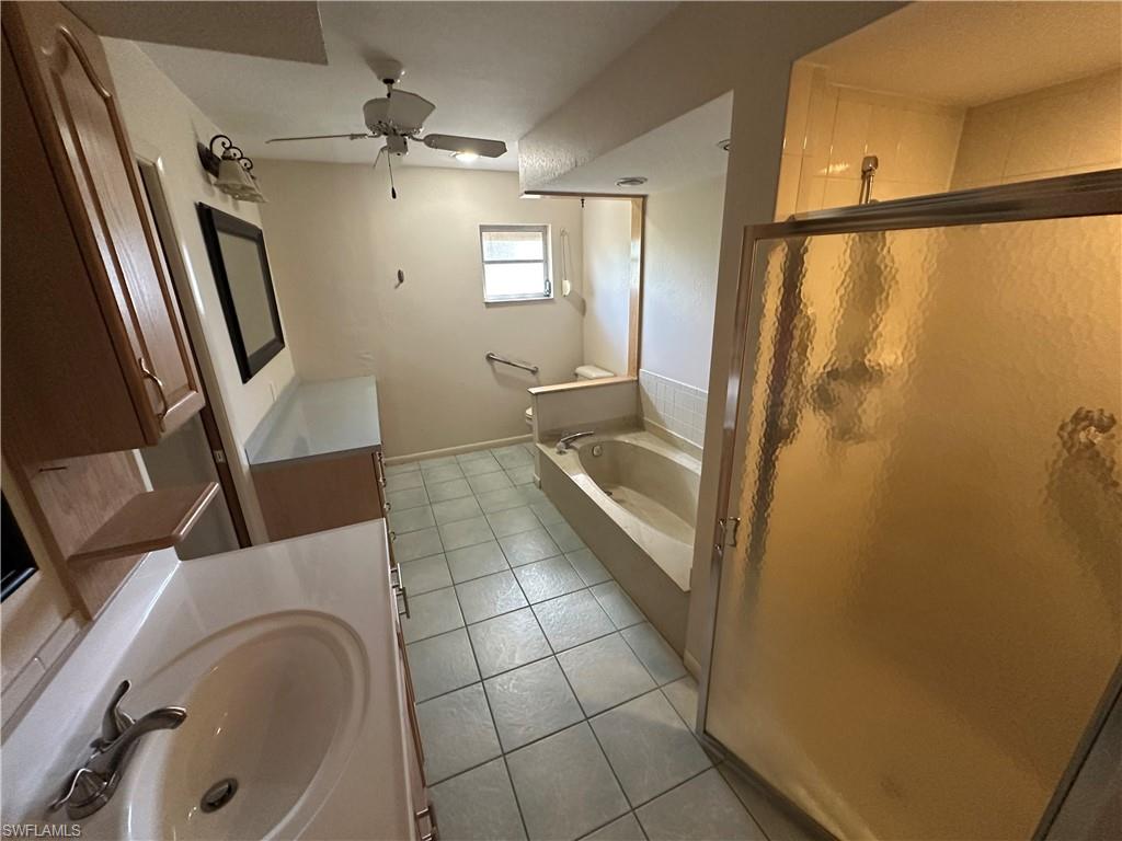 Kitchen with a kitchen island, stainless steel refrigerator with ice dispenser, lofted ceiling, ceiling fan, and recessed lighting
