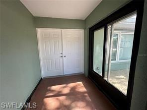 Back of property with a sunroom and a yard
