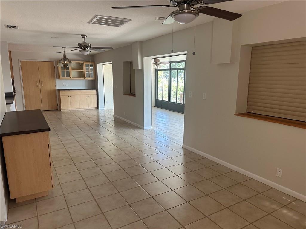 Kitchen with appliances with stainless steel finishes, ceiling fan, recessed lighting, decorative backsplash, and hanging light fixtures