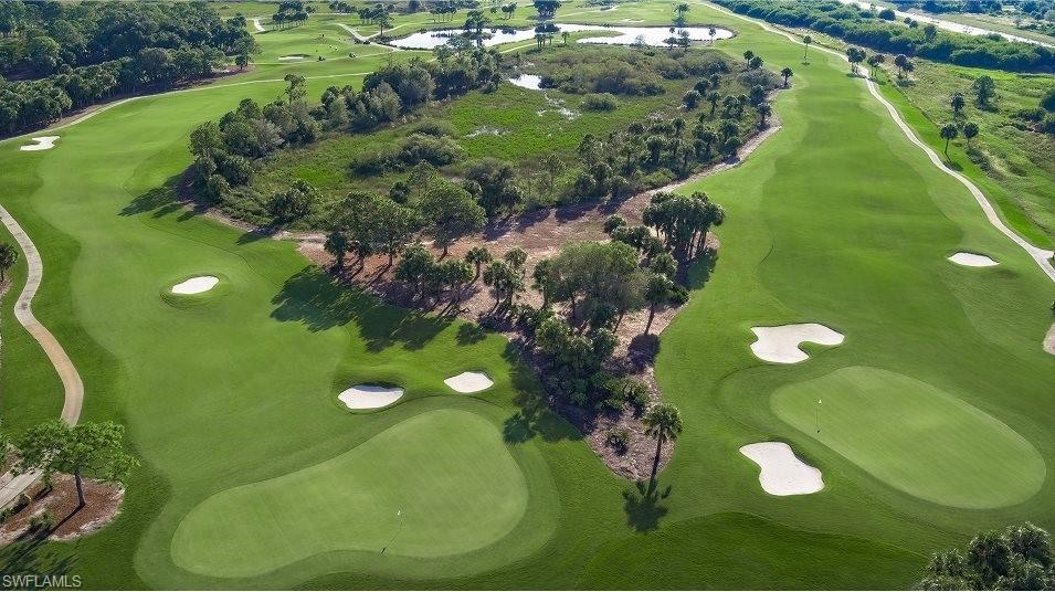 Aerial view of property's location with a golf club and a large body of water