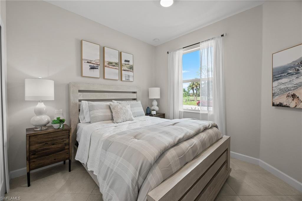 Bedroom with light tile patterned floors and baseboards