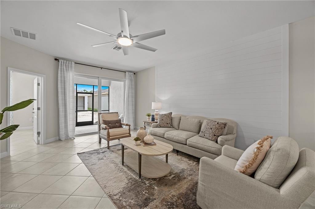 Living area with light tile patterned floors and ceiling fan