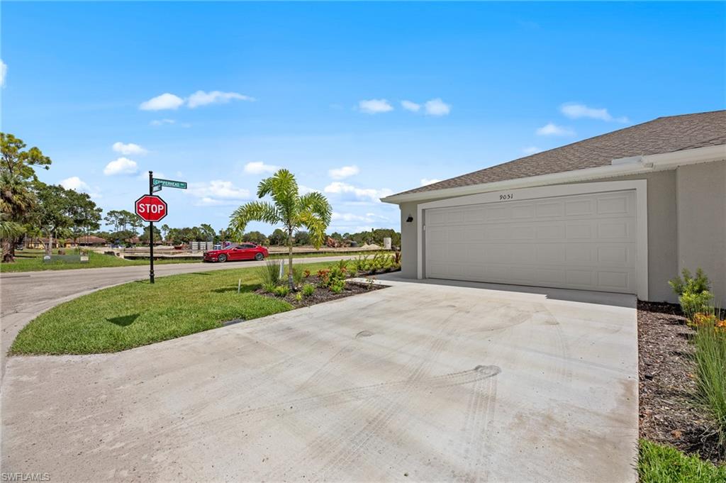 Garage featuring concrete driveway