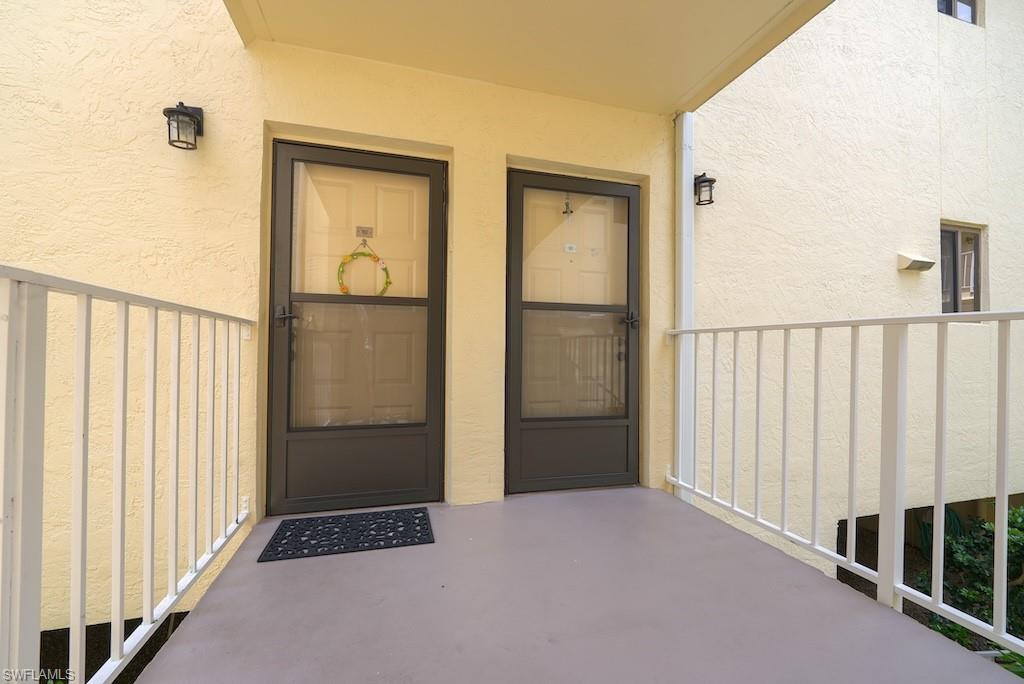 View of exterior entry featuring stucco siding and board and batten siding