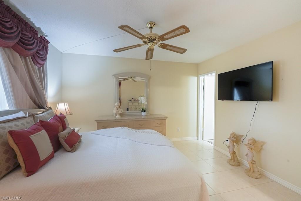 Bedroom with light tile patterned flooring and a ceiling fan