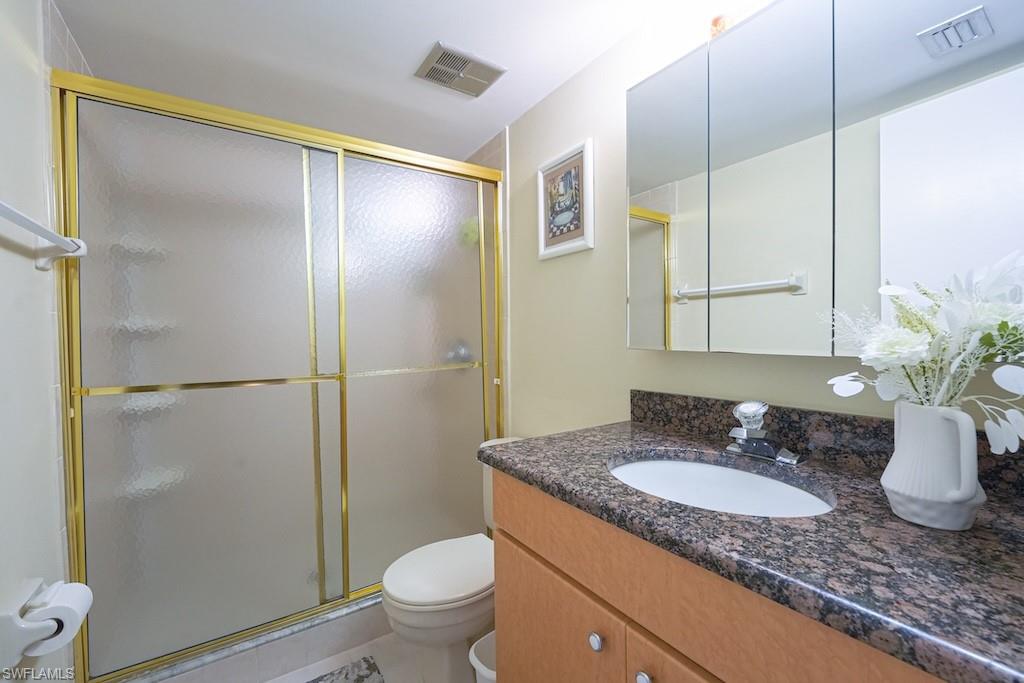 Bathroom featuring vanity and a shower stall