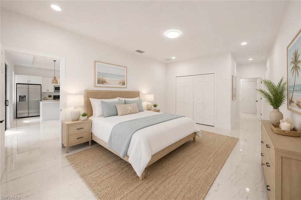 High ceilings and recessed lighting complement the white walls and light-toned flooring