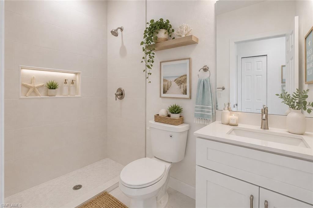 Walk-in shower with tiled walls and an illuminated niche