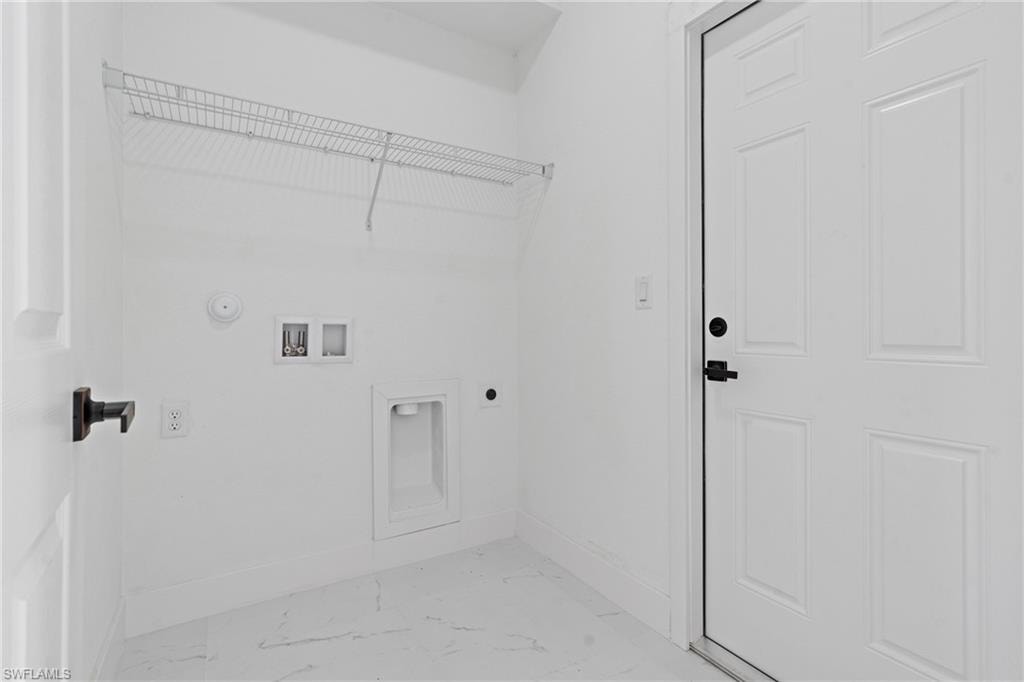 Washroom with hookup for an electric dryer, light marble finish floors, washer hookup, and gas dryer hookup