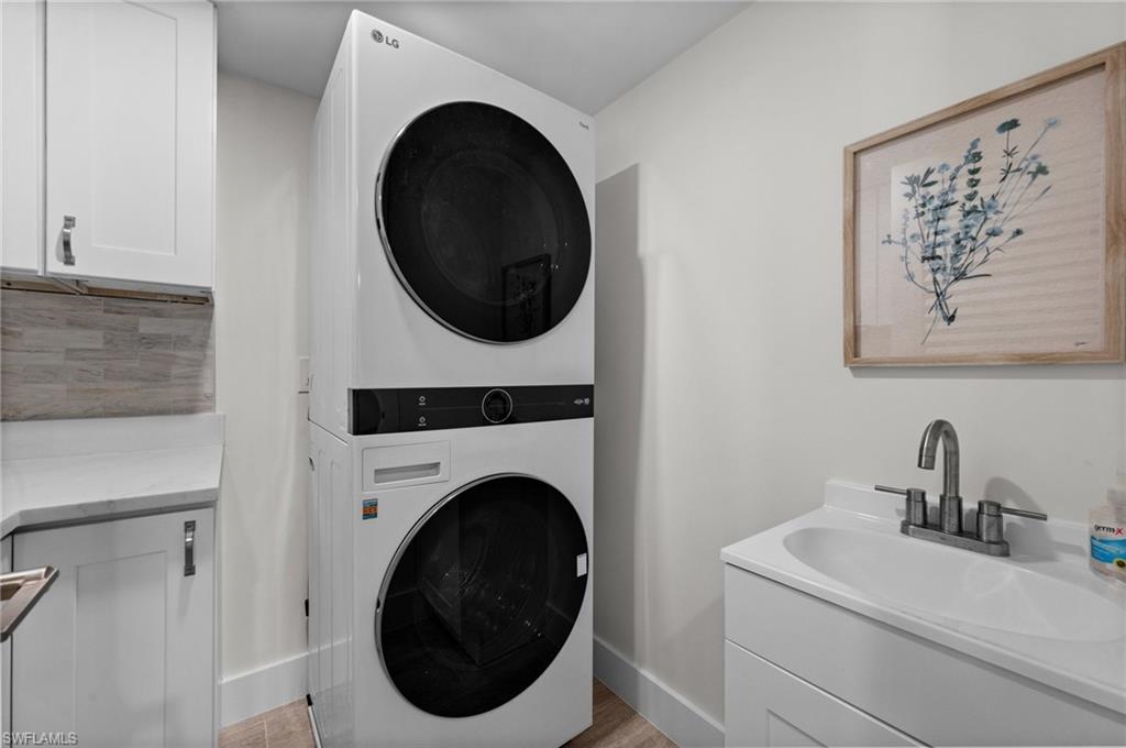 Full size in unit Laundry with Cabinets and sink.
