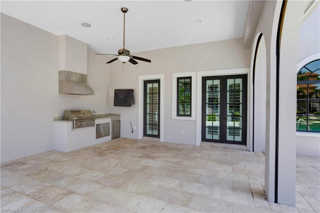 View of patio featuring exterior kitchen, ceiling fan, and french doors