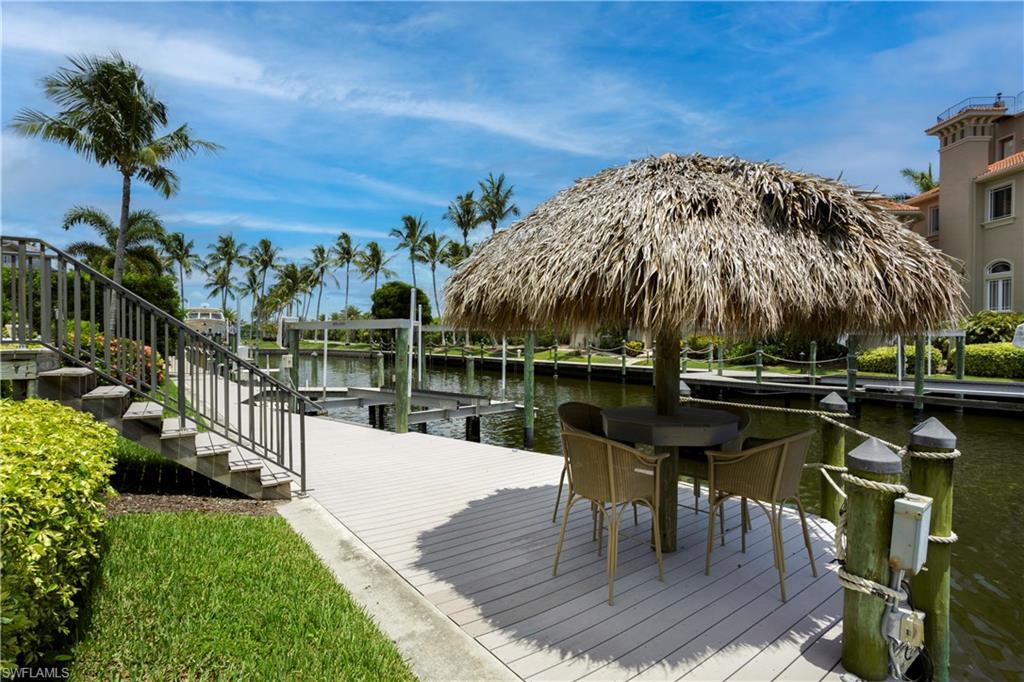 Private 92 ft composite dock area featuring a tiki hut, boat and jet ski lifts