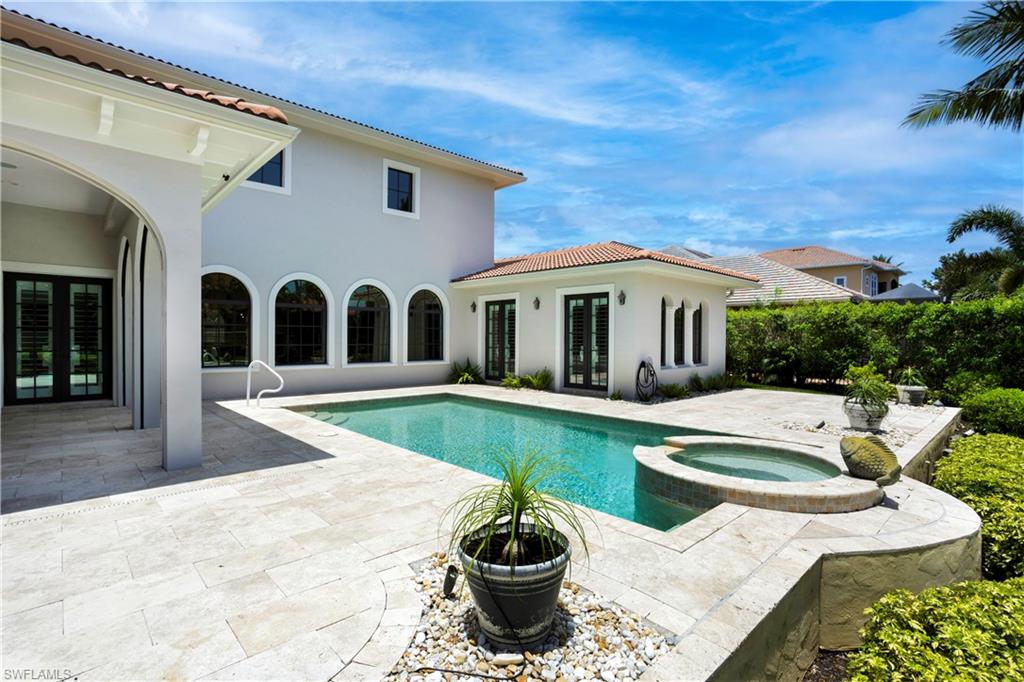 View of pool featuring french doors, a patio, and a pool with connected hot tub