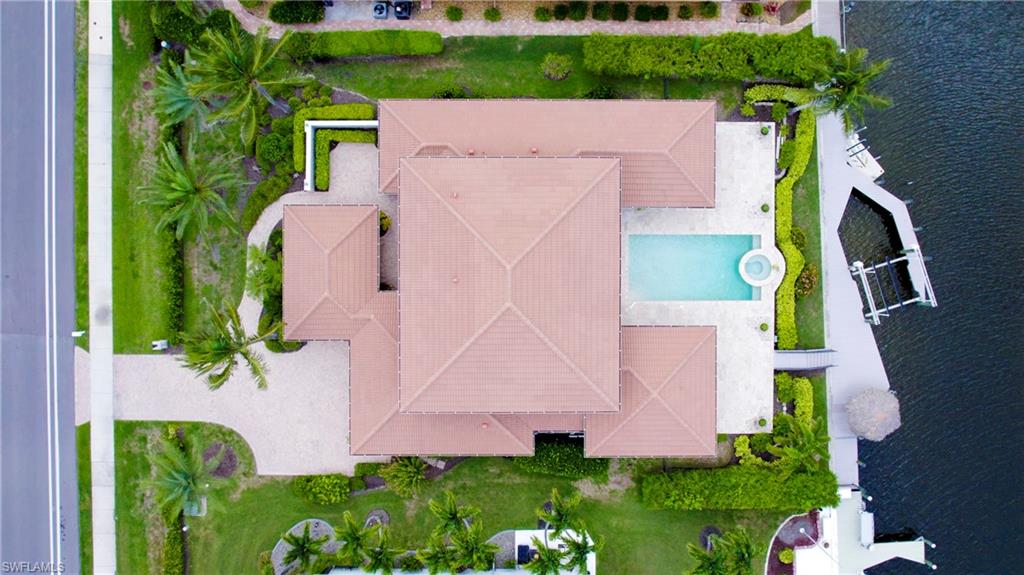 Aerial view of a pool and a nearby body of water