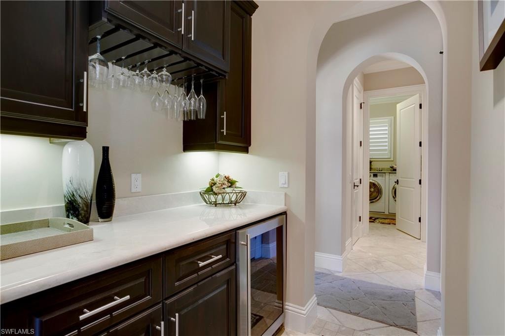 Butlers Pantry and Wine Bar with beverage cooler and arched walkways