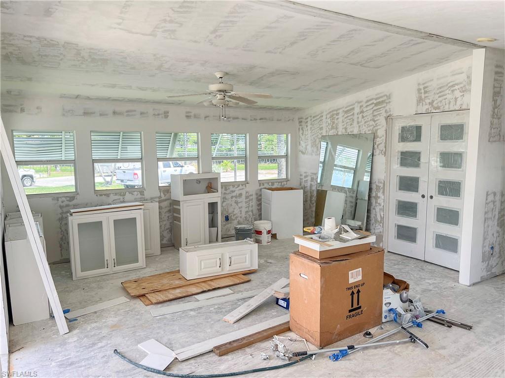 Living area with french doors to bedroom and new cabinets