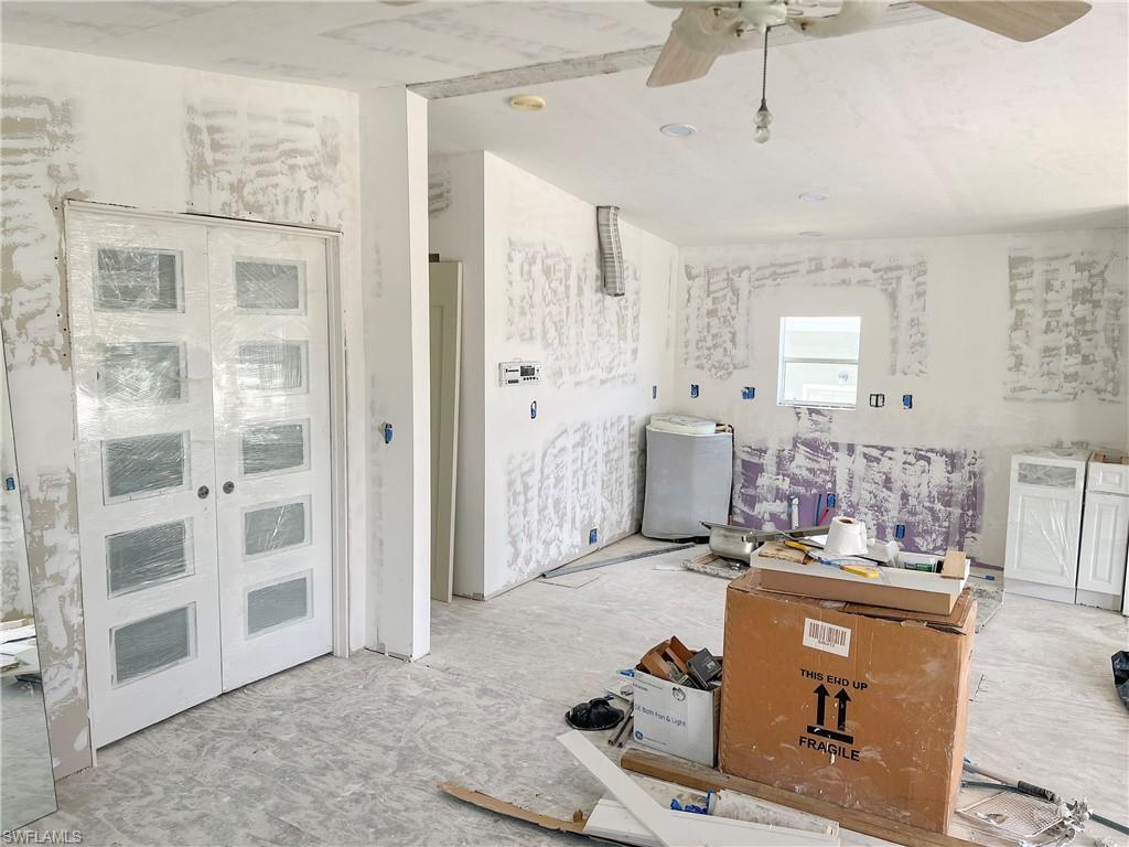 Living area with french doors to bedroom and new cabinets