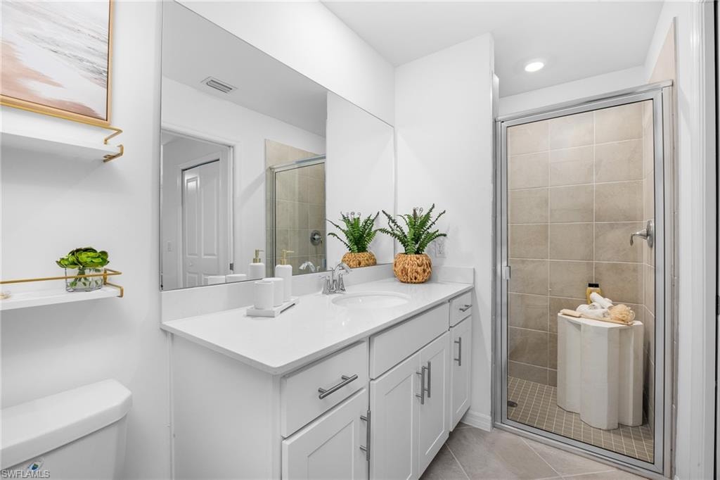 Bathroom with vanity, tile patterned flooring, a shower stall, and recessed lighting